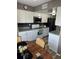 Updated kitchen featuring granite countertops, stainless steel appliances, a black backsplash, and a breakfast nook at 1001 Plantation Dr # A2, Kissimmee, FL 34741