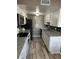 Updated kitchen featuring white cabinets, granite countertops, stainless steel appliances, and modern backsplash at 1001 Plantation Dr # A2, Kissimmee, FL 34741