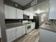 A modern kitchen with white cabinets, stainless steel appliances, granite countertops, and a stylish backsplash at 1001 Plantation Dr # A2, Kissimmee, FL 34741