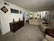 Spacious living room with neutral carpeting, stylish decor, and a mirrored wall for added depth at 1001 Plantation Dr # A2, Kissimmee, FL 34741
