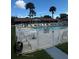 Community pool surrounded by chairs, greenery, and palm trees under a sunny sky at 1001 Plantation Dr # A2, Kissimmee, FL 34741