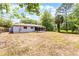 Back of home with screened in porch and spacious backyard with mature trees at 10105 Crozier Ct, Orlando, FL 32817