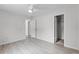 Spacious bedroom features light wood-look floors, ceiling fan, and closet at 10105 Crozier Ct, Orlando, FL 32817