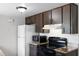 Well-lit kitchen features modern appliances, granite counters, tile backsplash, and ample storage space at 10105 Crozier Ct, Orlando, FL 32817