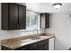 Kitchen with granite countertops, stainless steel sink, wood cabinets, and subway tile backsplash at 10105 Crozier Ct, Orlando, FL 32817