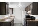 Well-appointed kitchen with dark cabinets, granite countertops, stainless steel sink, and modern appliances at 10105 Crozier Ct, Orlando, FL 32817