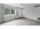Bright living room with neutral walls, large window, gray plank flooring and ceiling fan at 10105 Crozier Ct, Orlando, FL 32817