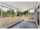 Enclosed screen porch with gray tile flooring overlooking backyard and wooden fence at 10105 Crozier Ct, Orlando, FL 32817