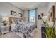 Cozy bedroom with patterned bedding and curtains, bedside tables, and natural light at 10128 Huntingnet Way, Leesburg, FL 34748
