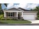 Charming single-story home with a two-car garage and manicured lawn at 10128 Huntingnet Way, Leesburg, FL 34748