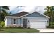 Charming single Gathering home showcases a two-car garage, stone accents, professional landscaping, and craftsman details at 10132 Huntingnet Way, Leesburg, FL 34748