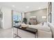 Bright living room featuring stylish decor, a comfortable sofa, a wall-mounted TV, and abundant natural light at 10132 Huntingnet Way, Leesburg, FL 34748