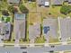 A bird's-eye view of the property, community, and street, revealing backyard size and solar panels at 1028 Sadie Ridge Rd, Clermont, FL 34715