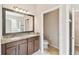 Bathroom featuring double sink vanity with granite counters and tile floor at 1028 Sadie Ridge Rd, Clermont, FL 34715