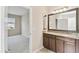 Large bathroom featuring a double vanity, tile floors, and lots of natural light at 1028 Sadie Ridge Rd, Clermont, FL 34715