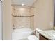 Bathroom featuring a bathtub with tiled walls, and a white toilet at 1028 Sadie Ridge Rd, Clermont, FL 34715