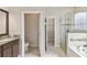 Bright bathroom with a separate toilet room, walk-in shower and large soaking tub at 1028 Sadie Ridge Rd, Clermont, FL 34715