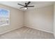 Carpeted bedroom with a ceiling fan and a window at 1028 Sadie Ridge Rd, Clermont, FL 34715