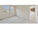 Bright bedroom features neutral carpet, two large windows and is conveniently located next to the kitchen at 1028 Sadie Ridge Rd, Clermont, FL 34715