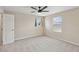 Cozy, sunlit bedroom featuring plush carpeting and large windows offering backyard views at 1028 Sadie Ridge Rd, Clermont, FL 34715
