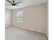 Bright bedroom features plush carpet, a ceiling fan, and a window with natural light at 1028 Sadie Ridge Rd, Clermont, FL 34715