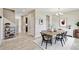 Bright dining room featuring a modern light fixture, a wooden table and seating for six, and stylish decor at 1028 Sadie Ridge Rd, Clermont, FL 34715