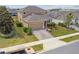Charming two-story home with a well-manicured lawn, a brick driveway, and a two car garage at 1028 Sadie Ridge Rd, Clermont, FL 34715