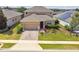 Beautiful home with a well-manicured lawn, a brick driveway, and lush landscaping at 1028 Sadie Ridge Rd, Clermont, FL 34715