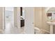 Hallway with tile flooring leading to a half bathroom and the kitchen at 1028 Sadie Ridge Rd, Clermont, FL 34715