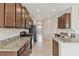 Well-lit kitchen featuring granite countertops, stainless steel appliances, and tile flooring at 1028 Sadie Ridge Rd, Clermont, FL 34715