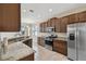 Well-equipped kitchen with stainless steel appliances, granite countertops and dark wood cabinets at 1028 Sadie Ridge Rd, Clermont, FL 34715