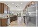 Well-equipped kitchen with stainless steel appliances, granite countertops and dark wood cabinets at 1028 Sadie Ridge Rd, Clermont, FL 34715