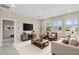 Comfortable living room with a neutral color scheme, large windows for natural light, and stylish furniture at 1028 Sadie Ridge Rd, Clermont, FL 34715