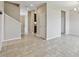 Open-concept living room with neutral paint, tile floors, and a view of the staircase at 1028 Sadie Ridge Rd, Clermont, FL 34715