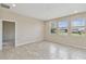 Bright living room featuring tile flooring and multiple windows for ample natural light at 1028 Sadie Ridge Rd, Clermont, FL 34715