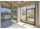 Screened patio with a view of the home's exterior and a glimpse of the landscaped yard at 1028 Sadie Ridge Rd, Clermont, FL 34715