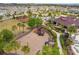 Aerial view of a fun playground and recreation area with playground equipment and a nearby pool and clubhouse at 1028 Sadie Ridge Rd, Clermont, FL 34715