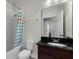 Clean bathroom featuring a vanity with a dark countertop, white toilet, and shower with curtain at 1052 Avila Ln, Orlando, FL 32803
