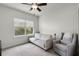 Well-lit bedroom featuring a large window, comfortable couch, and cozy armchair perfect for relaxation at 1052 Avila Ln, Orlando, FL 32803