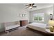 Bright bedroom featuring neutral walls, carpet, ceiling fan, and window with tree view at 1052 Avila Ln, Orlando, FL 32803