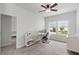 Bright bedroom featuring neutral walls, carpet, ceiling fan, and an area for office work at 1052 Avila Ln, Orlando, FL 32803