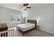 Bright bedroom featuring neutral walls, carpet, ceiling fan, and a window view at 1052 Avila Ln, Orlando, FL 32803