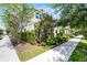 Exterior view featuring manicured landscaping, sidewalks, and a well-maintained neighborhood at 1052 Avila Ln, Orlando, FL 32803