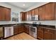Kitchen featuring wood cabinets, stainless steel appliances, and granite countertops at 1052 Avila Ln, Orlando, FL 32803