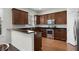 View of kitchen features with wood cabinets, stainless steel appliances, and hard wood floor at 1052 Avila Ln, Orlando, FL 32803