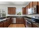 Kitchen with stainless steel appliances, granite counter tops and wood cabinets at 1052 Avila Ln, Orlando, FL 32803