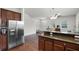Open-concept living area with stainless steel refrigerator, and kitchen bar at 1052 Avila Ln, Orlando, FL 32803