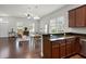 Open-concept living area with hardwood floors, kitchen bar, and dining space at 1052 Avila Ln, Orlando, FL 32803