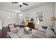Bright living room featuring a ceiling fan, modern furniture, and lots of natural light at 1052 Avila Ln, Orlando, FL 32803