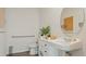Modern bathroom featuring a sleek vanity with a stylish sink, a round mirror, and accessible grab bars at 1078 Clay Blvd, Tavares, FL 32778
